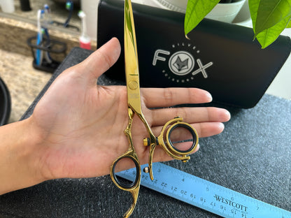 Scissors held in palm of hand.