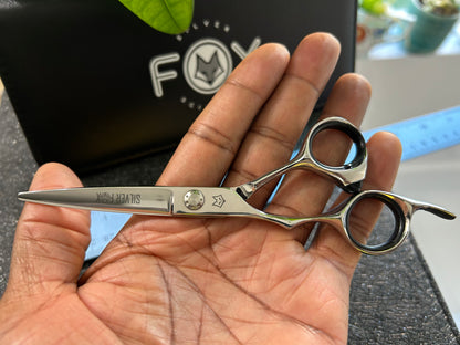 Scissors resting against palm of hand.