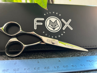 Scissors resting against black case.