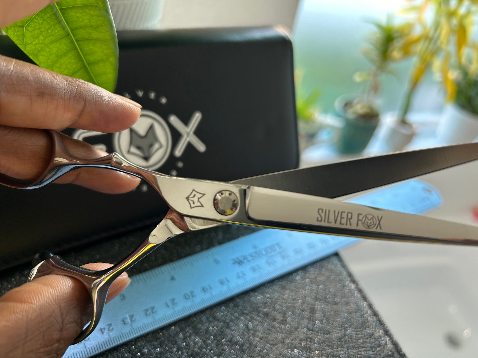 Scissors held with fingers threaded through rings.