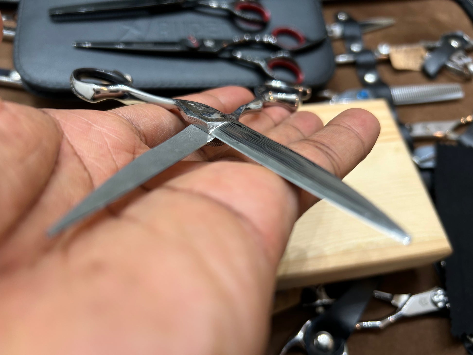 Scissors in cutting position held in hand.