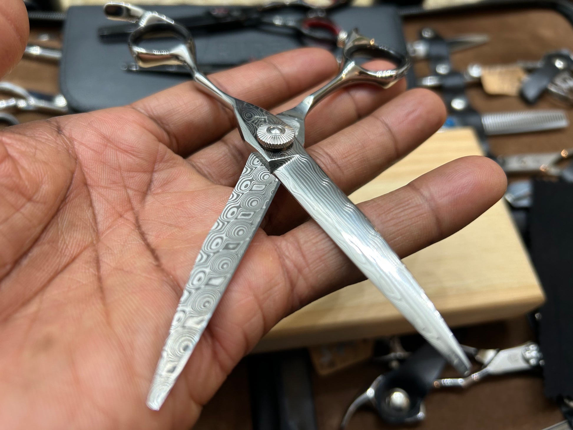 Scissors in cutting position held in hand.