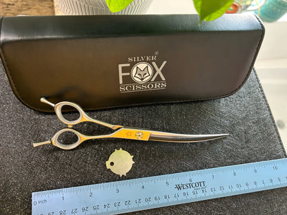 Top view of scissors with ruler for scale.