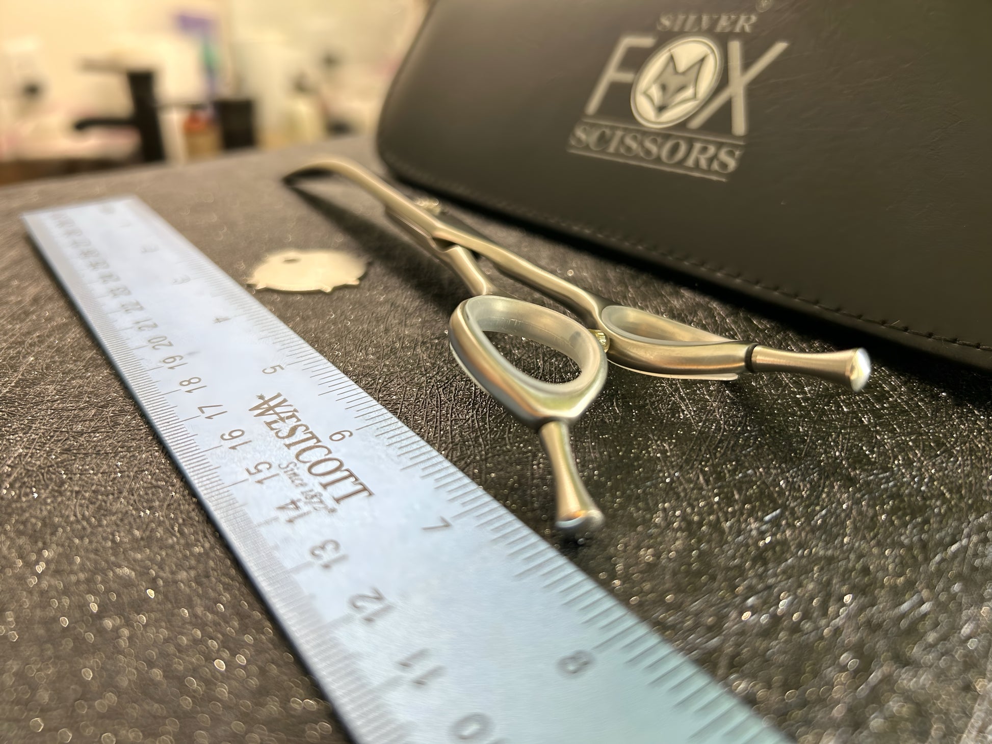 Close up view of back of scissors with ruler for scale.