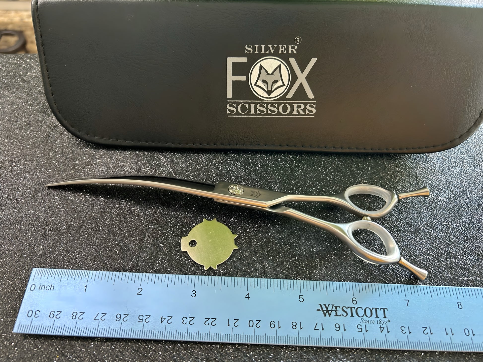 Top view of scissors with ruler for scale.