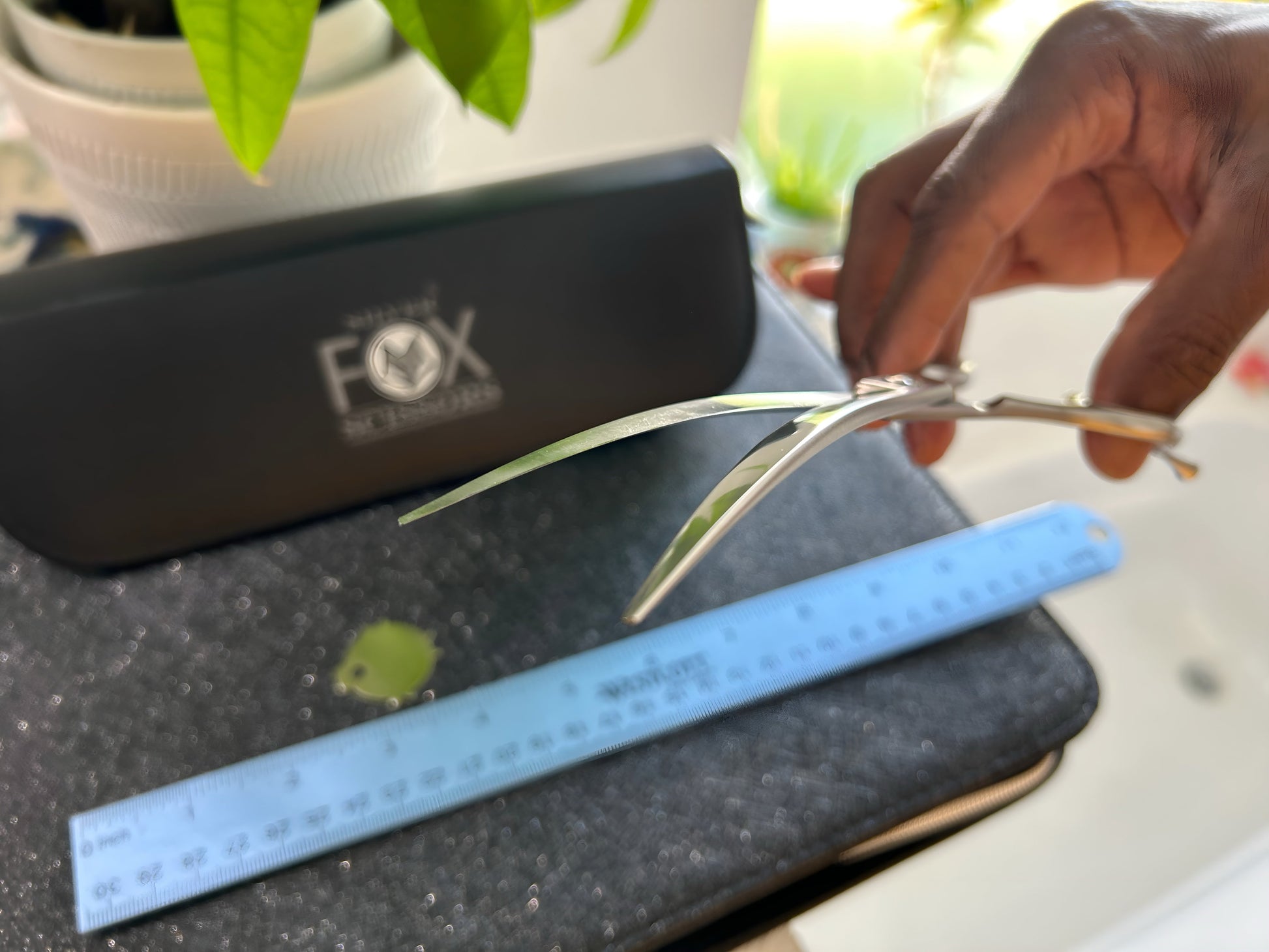 Scissors held with fingers threaded through rings.