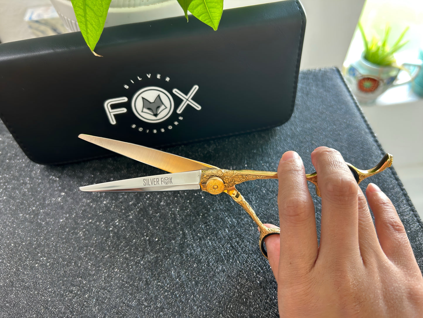 Scissors held with fingers threaded through rings.