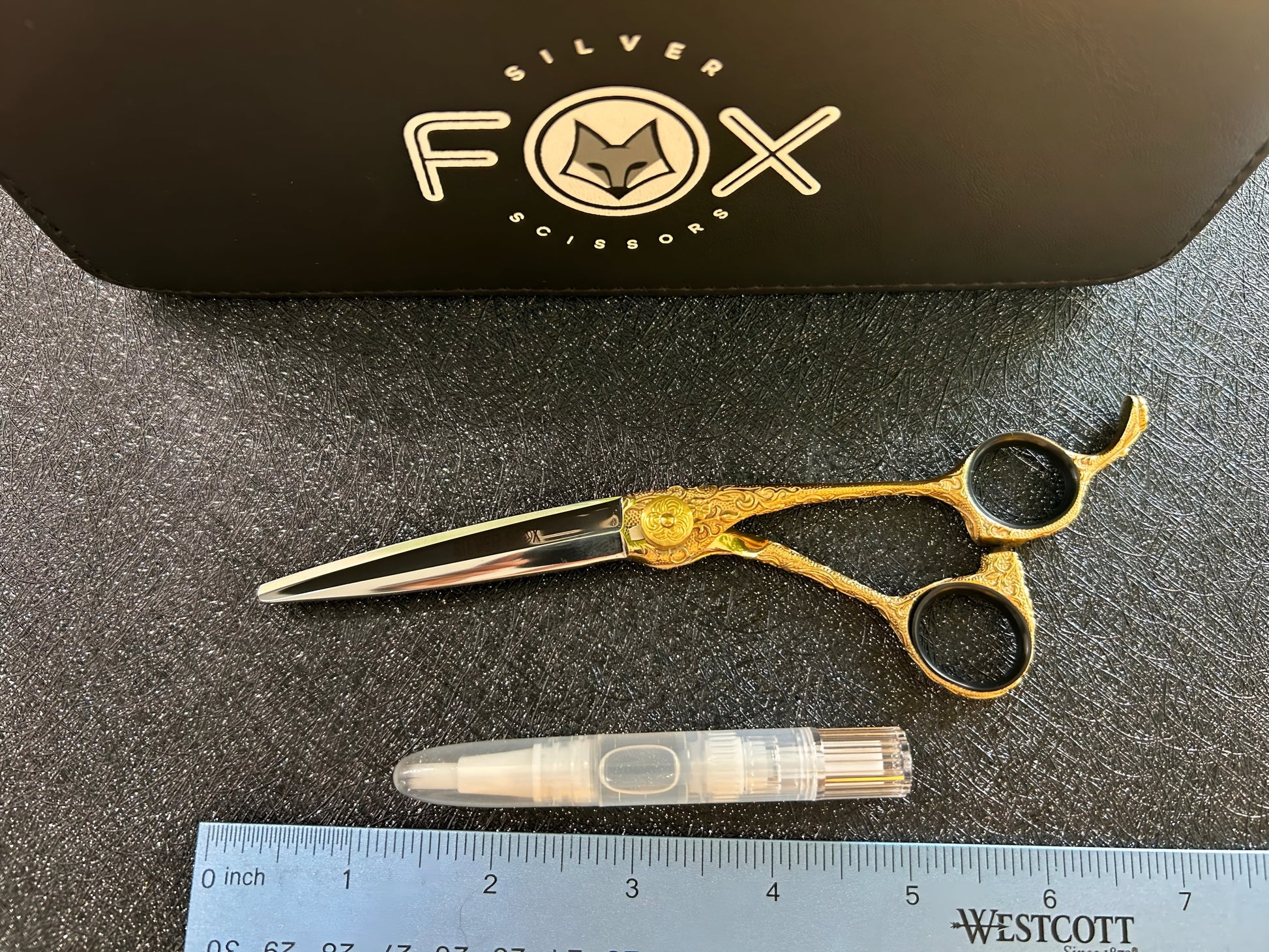 Top view of scissors with ruler for scale.