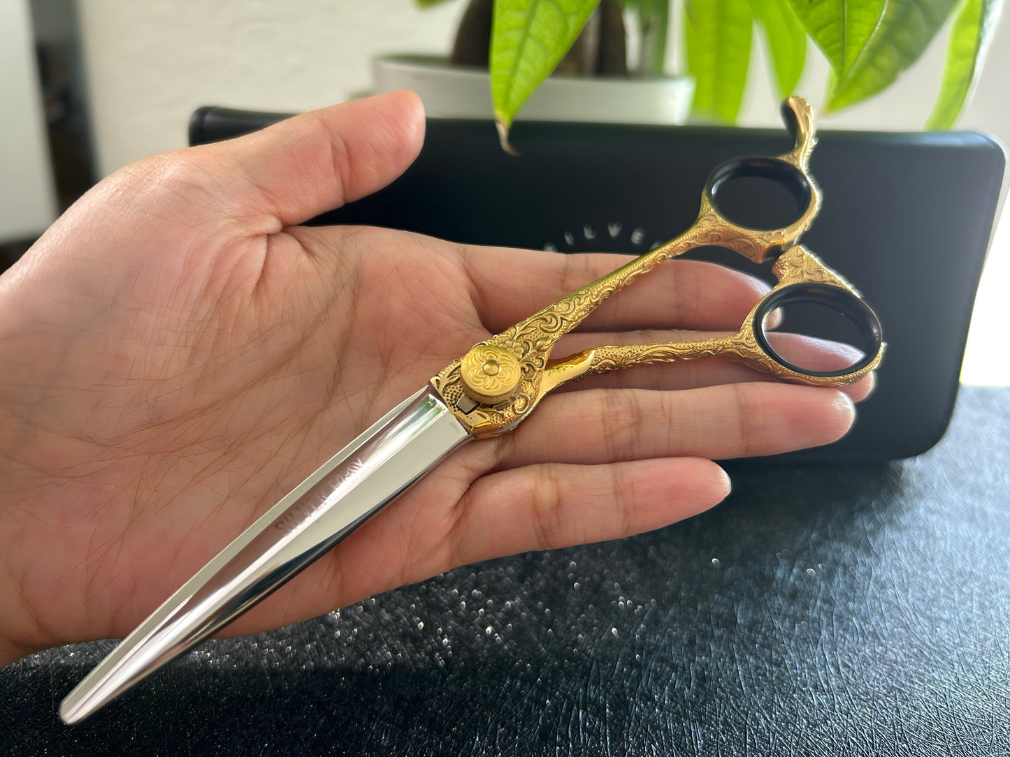 Scissors held in palm of hand.